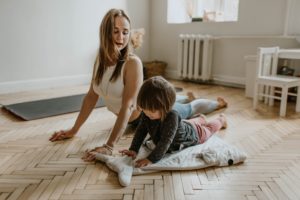 mother does yoga workout with child